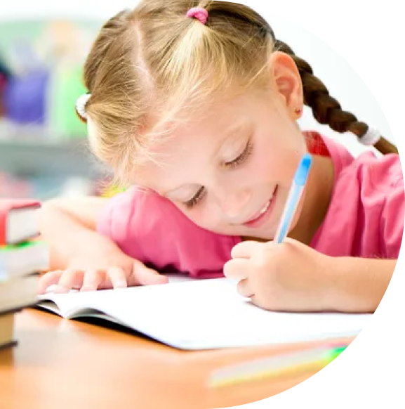 Little girl writing on her desk