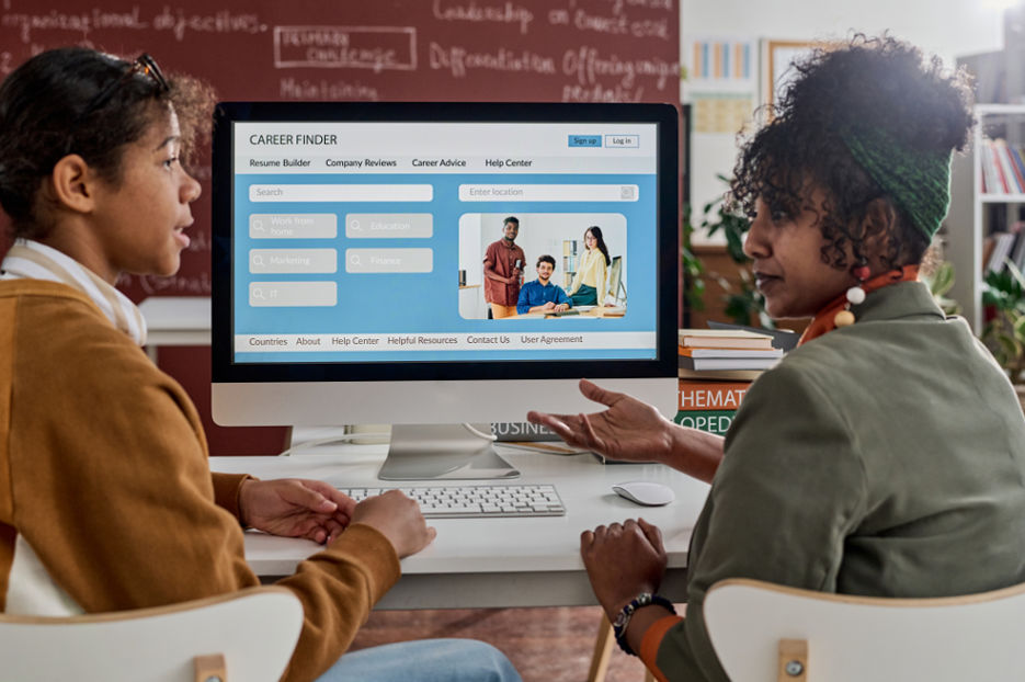 Two Black Students Discussing during Online Class